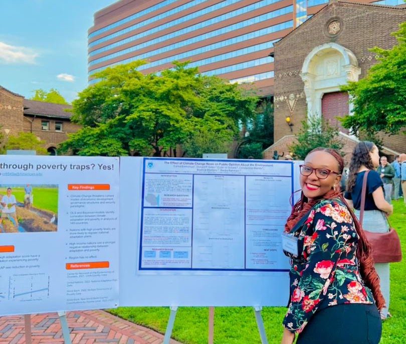 Salma Emmanuel beside a research poster